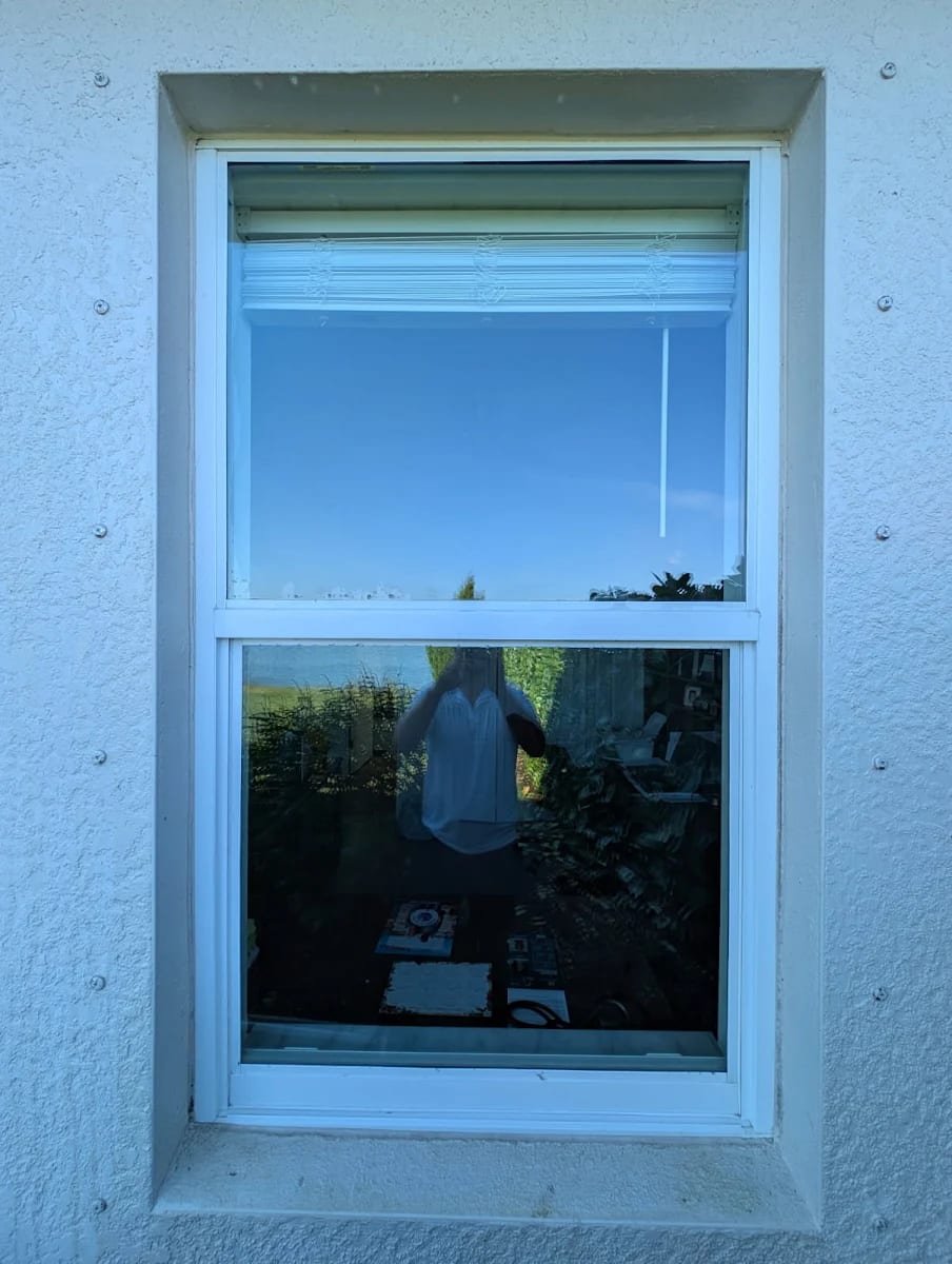 The same window after LUX cleaning — crystal-clear glass and a spotless sill